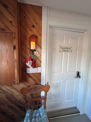 A wooden interior with a white door labeled "Garden View."