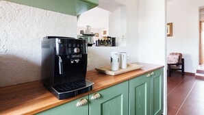 A coffee machine on a wooden counter with a green cabinet below. - La Villa del Relax - Two Bedroom Villa, Sleeps 4 (Sennori)