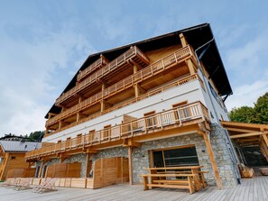 A multi-story building with wooden balconies and stone walls. - Chalet in Combloux With Mont-blanc Views (Combloux)