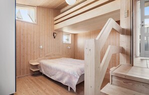 A wooden interior with a bed, a small window, and a staircase. - Stunning home in Blokhus with WiFi (Blokhus)
