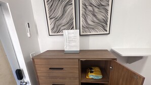 A compact kitchen with a wooden cabinet, a built-in microwave, and a small refrigerator.