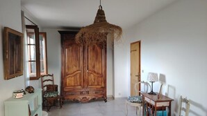 A spacious room with a large wooden wardrobe, a hanging light fixture, and a bookshelf. - LE PERCHOIR - LES MAYONS (LES MAYONS)