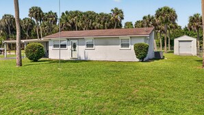 A single-story house with a sloped roof, a front door, and a small porch. - Quiet Getaway Near Ft. Myers • Relax & Unwind (Alva)