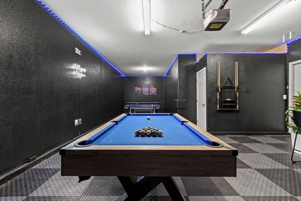 A pool table with balls, a ping pong table, and a billiards rack in a room with black walls and blue LED strip lighting. - 2700sqft/Heated Pool, Hot Tub. 15min to Strip! (North Las Vegas)