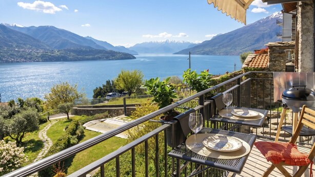 A balcony with outdoor dining furniture overlooking a lake and mountains. - Ca' Il Nido by Interhome (Domaso)