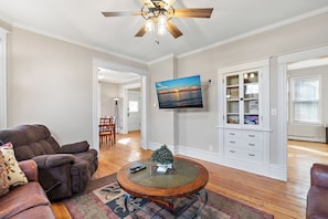 Relax in this cozy living space with a flat-screen TV, comfortable recliner, and potted plant.