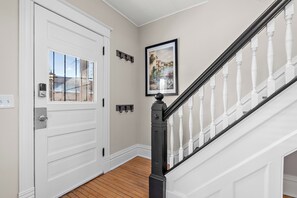 Stunning entryway with a classic staircase and elegant artwork.