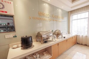 A kitchen with a countertop, a wall-mounted kettle, and a window with curtains. - City Zhixin Boutique Hotel (Infrastructure Camp Central Hospital) (Xiangtan)