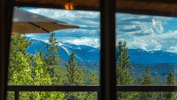 A view from inside a building with a window overlooking a mountain range.