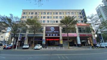A multi-story hotel with a prominent sign for the Starry Hotel.