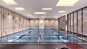 A swimming pool with lanes, a changing room, and a view of the city.