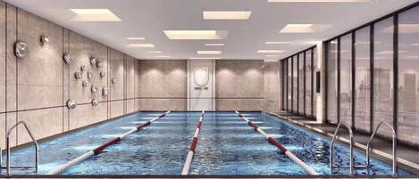 A swimming pool with lanes, a changing room, and a view of the city.