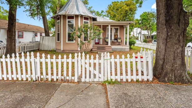 A small, single-story house with a gabled roof and a porch.