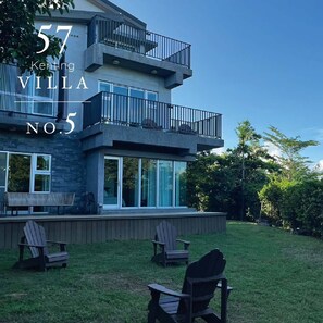 A modern villa with a balcony, large windows, and outdoor seating. - 57villa (Hengchun)