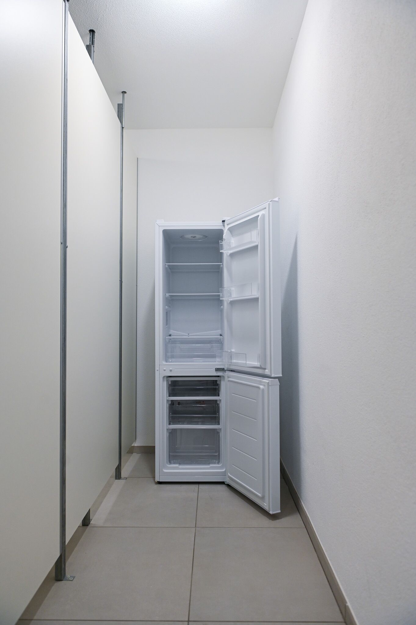 A corner of a room with a white wall and a white door.