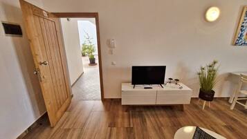 Comfort Apartment, City View | Living area | 80-cm flat-screen TV with cable channels