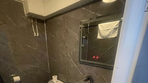 A bathroom with a toilet, sink, and mirror. - The Sneyd Arms Hotel (Stoke-on-Trent)
