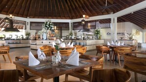 A spacious restaurant with wooden furniture and a high ceiling. - Lifestyle Tropical Beach (Puerto Plata)