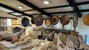 A room with hammocks and a variety of decorative plates hanging from the ceiling. - Peaceful Cottage in Sound Healing Retreat (Cardigan)