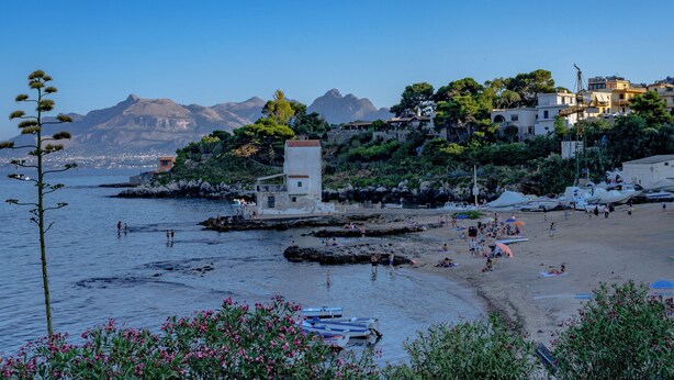 A coastal town with a beach, boats, and a tower. - VFH The Castle Bay apartment and terrace (Santa Flavia)