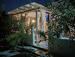 A covered outdoor area with potted plants and a glass structure. - Romantic Puglian Hideaway for couples with Panoramic Sea Views  (Carovigno)