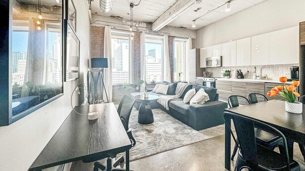 A modern apartment with a dining area, living room, and kitchen. - Elegant 2BD | DT Dallas | Sleeps 5 | ValetParking (Dallas)