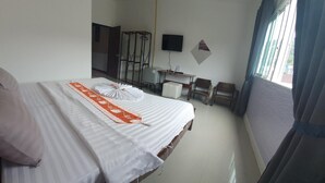 A hotel room with a bed, a desk, a chair, and a TV. - Athome Hotel Nanai 8 (Patong)
