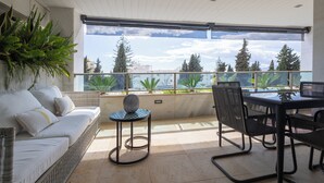 A balcony with a sofa, table, chairs, and potted plants. - Luxury oasis in the heart of Marbella (Marbella)