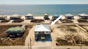 An aerial view of a coastal area with beach houses, a road, and the ocean. - NEW! "Days Like This" 5/5, Private POOL, Sleeps 14, Easy Gulf Beach Access (Dauphin Island)