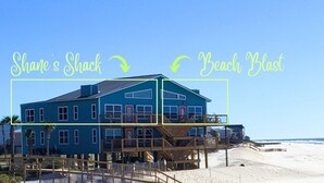 A two-story beachfront property with a balcony and a staircase leading to the upper level. - Beach Blast: Gulf-Front 3bd/2ba on North Cape - Ocean Views From Every Room (Port St. Joe)