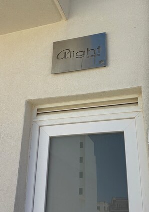 A sign with the text "A Light Residence" mounted above a white-framed door. - Alight Sauna and SPA Penthouse (Xewkija)