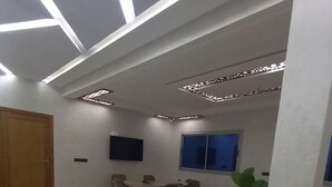 A spacious room with a dining area, a large window, and a ceiling with recessed lighting. - Charming apartment in wonderful Fes with WiFi, AC (Fes)