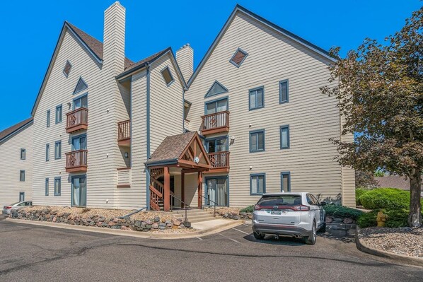 A multi-story hotel with a symmetrical facade, balconies, and a central entrance with a covered porch.