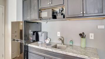 Fridge, microwave, coffee/tea maker, cookware/dishes/utensils