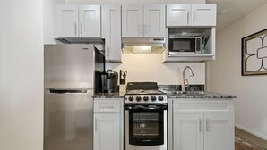 A compact kitchen with white cabinets, a stainless steel refrigerator, a microwave, a stove, and an oven. - DTC Studio w/ Kitchenette, Fast WiFi,Free Parking! (Greenwood Village)