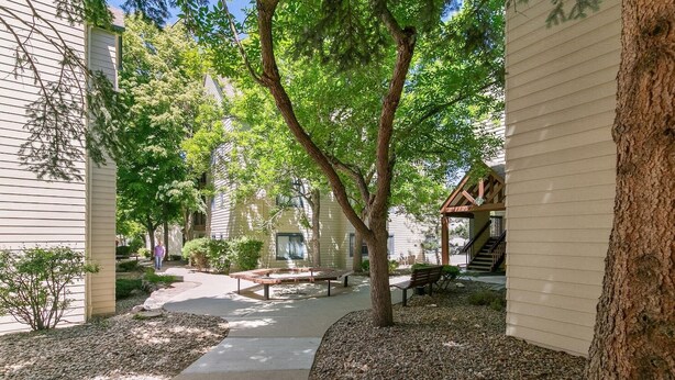 A courtyard with a covered seating area, a pathway, and a building with a staircase. - DTC Studio w/ Kitchenette, Fast WiFi,Free Parking! (Greenwood Village)