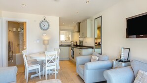 A modern apartment with a dining area, kitchen, and living room. - 2 bedroom accommodation in Brixham (Brixham)