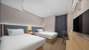 A hotel room with two beds, a desk, a chair, a flat-screen TV, and a window with curtains. - Shanghai Nalan Hotel (Shanghai)