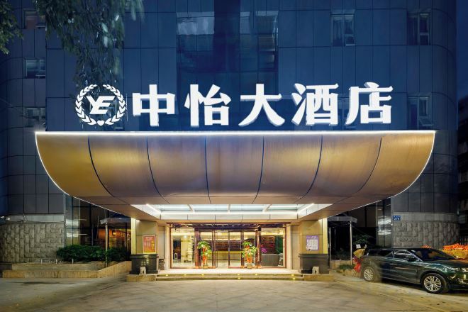 A hotel entrance with a modern design, featuring a prominent awning and a clear entrance.