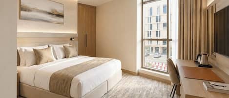 Deluxe Room, 1 King Bed | In-room safe, laptop workspace, blackout drapes, iron/ironing board