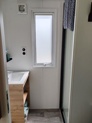 Shower, hair dryer, soap, toilet paper