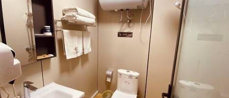 A bathroom with a sink, a toilet, a shower, and a towel rack.