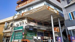 A building with multiple signs, including 'FabHotels', 'Raapi Sa', and 'Rooms & Restaurant'. - Hotel 24x7 Inn (Jalandhar)