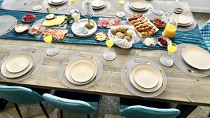 A dining table set for a meal with plates, cutlery, and various food items. - The Old School House (Barnsley)