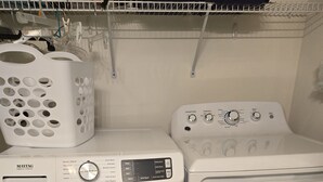 A Maytag washer and dryer unit in a laundry room with a wooden floor. - Sandpiper Bay 3rd Floor. 4 mi to beach. 3 bd, 2 ba, new kitchen,  pool & more (Sunset Beach)