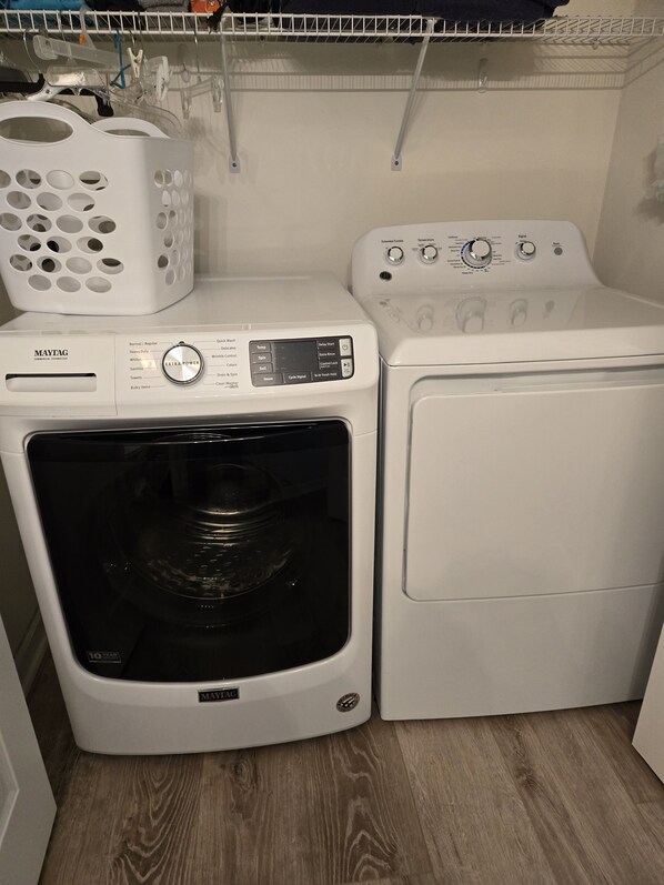 A Maytag washer and dryer unit in a laundry room with a wooden floor. - Sandpiper Bay 3rd Floor. 4 mi to beach. 3 bd, 2 ba, new kitchen,  pool & more (Sunset Beach)