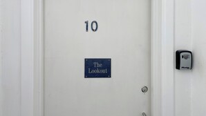 A white door with the number 10 and a sign that reads 'The Lookout.' - 1 bedroom accommodation in Sennen (Sennen)