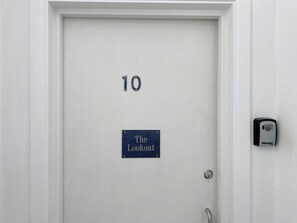 A white door with the number 10 and a sign that reads 'The Lookout.'