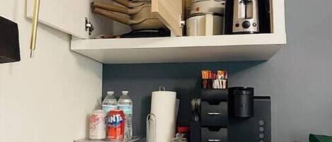 A kitchen with a microwave, coffee maker, and toaster on the countertop.