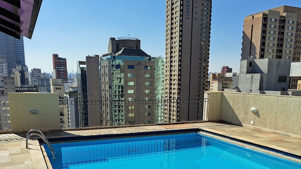 A rooftop pool with a cityscape view, including a tall building labeled 'STAYBRIDGE SUITES'.